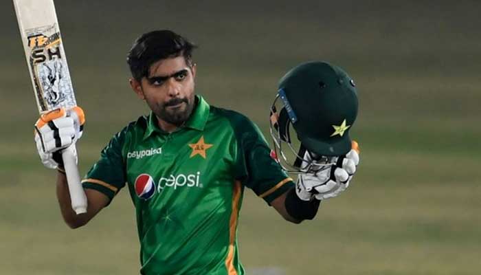 Pakistani skipper Babar Azam holds up his bat after scoring a century. Photo: AFP