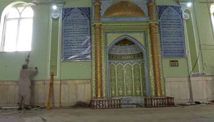 A man inspects damages inside a mosque in Kandahar on October 15, 2021, after a suicide bomb attack during Friday prayers that killed at least 33 people and injured 74 others, Taliban officials said. — AFP/File