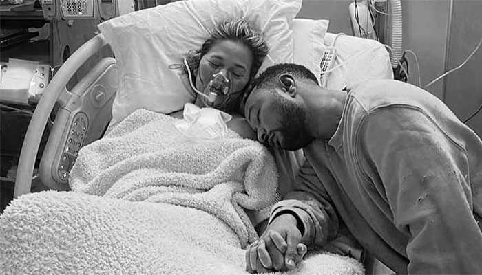 Chrissy Teigen says she felt ‘suctioned to the couch’ after pregnancy loss