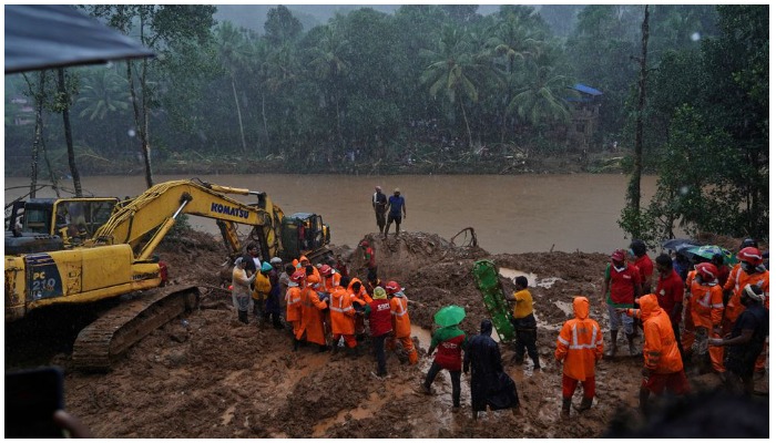 Rescue workers carry the body of a victim after recovering it from the debris of a residential house following a landslide caused by heavy rainfall at Kokkayar village in Idukki district in the southern state of Kerala, India, October 17, 2021. REUTERS