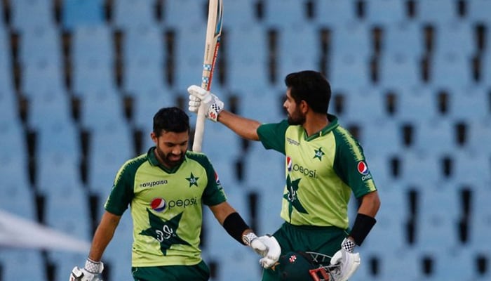 Pakistans captain Babar Azam (R) celebrates after scoring a century (100 runs) as Pakistans Mohammad Rizwan (L) looks on during the third Twenty20 international cricket match between South Africa and Pakistan at SuperSport Park in Centurion on April 14, 2021. — AFP/File