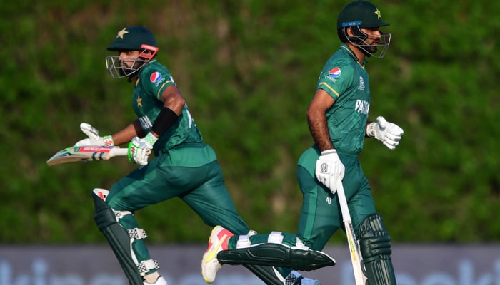 Captain Babar Azam (L) and Fakhar Zaman run between the wickets during the warmup cricket match between Pakistan and West Indies for the ICC Twenty20 World Cup at the ICC Cricket Academy Ground in Dubai on October 18, 2021. — AFP/File