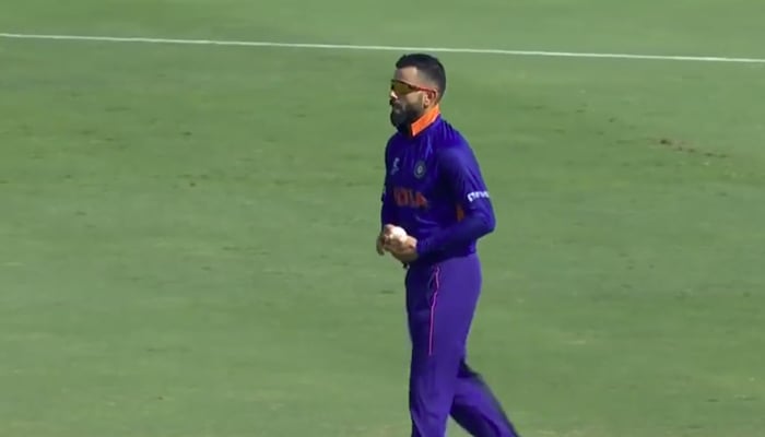 Indian skipper Virat Kohli bowls during a T20 World Cup warm-up match against Australia on October 20, 2021. — ICC