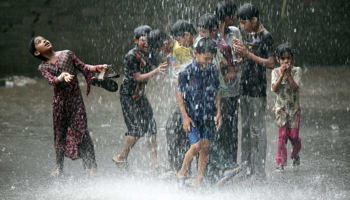 Children play in the rain in Lahore in this Reuters file photo.