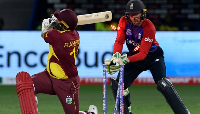 West Indies Ravi Rampaul (L) is clean bowled by Englands Adil Rashid (not pictured) as Englands wicketkeeper Jos Buttler watches during the ICC T20 World Cup cricket match between England and West Indies at the Dubai International Cricket Stadium in Dubai on October 23, 2021.— AFP