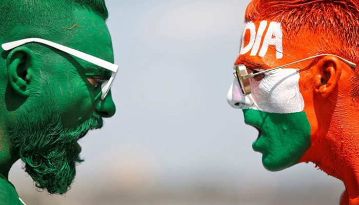 Cricket fans, with their faces painted in the Indian and Pakistani national flag colours, pose for a picture ahead of the first match between India and Pakistan in T20 World Cup super 12 stage in Dubai, in Ahmedabad, India. — Reuters/File