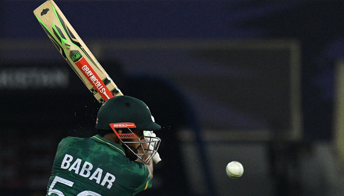 Pakistans captain Babar Azam plays a shot during the ICC Mens Twenty20 World Cup cricket match between India and Pakistan at the Dubai International Cricket Stadium in Dubai on October 24, 2021. Photo by Indranil Mukherjee/AFP