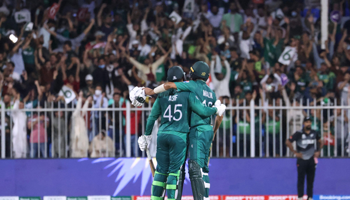 Pakistan´s Asif Ali (L) and Shoaib Malik embrace as they celebrate their victory at the end of the ICC Twenty20 World Cup cricket match between Pakistan and New Zealand at the Sharjah Cricket Stadium in Sharjah on October 26, 2021. — AFP