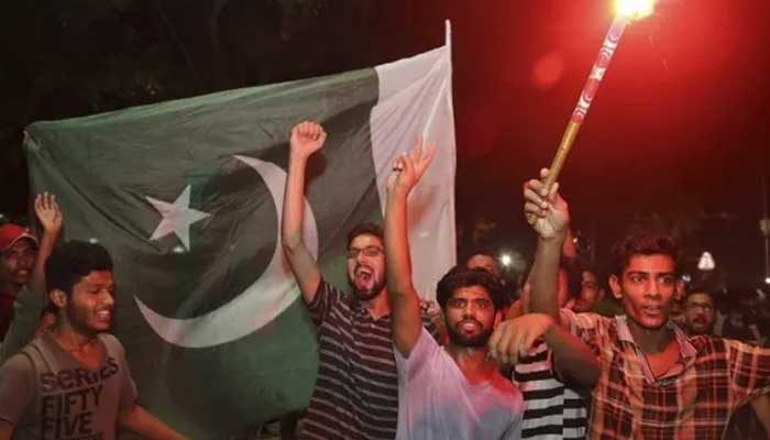 Fans celebrate Pakistans win against India on Sunday. Photo: Kashmir Media Service