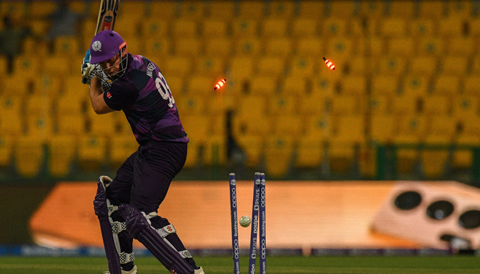 Scotland´s George Munsey is bowled out by Namibia´s Ruben Trumpelmann during the ICC men’s Twenty20 World Cup cricket match between Scotland and Namibia at the Sheikh Zayed Cricket Stadium in Abu Dhabi on October 27, 2021. — AFP