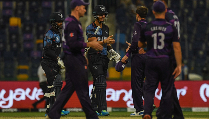 Namibia´s and Scotland´s cricketers greet each other after the end of play during the ICC menâ€™s Twenty20 World Cup cricket match between Scotland and Namibia at the Sheikh Zayed Cricket Stadium in Abu Dhabi on October 27, 2021. — AFP