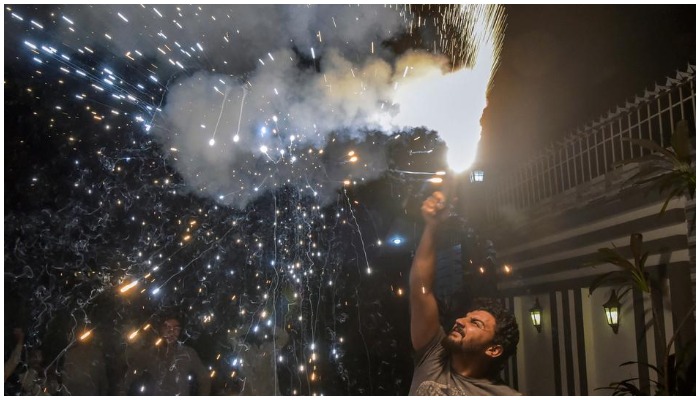 Pakistanis celebrate win of ICC men’s Twenty20 World Cup cricket match between Pakistan and India, at their home street in Peshawar, on October 24, 2021. (AFP)