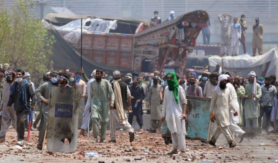 Supporters of the banned Islamist political party Tehreek-e-Labbaik Pakistan (TLP) with sticks and stones block a road during a protest in Lahore, Pakistan, Apr. 18, 2021. — Reuters.