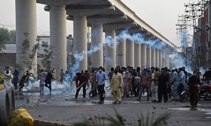 Police use tear gas to disperse supporters of Tehreek-i-Labbaik Pakistan (TLP) during a protest in Lahore. — AFP