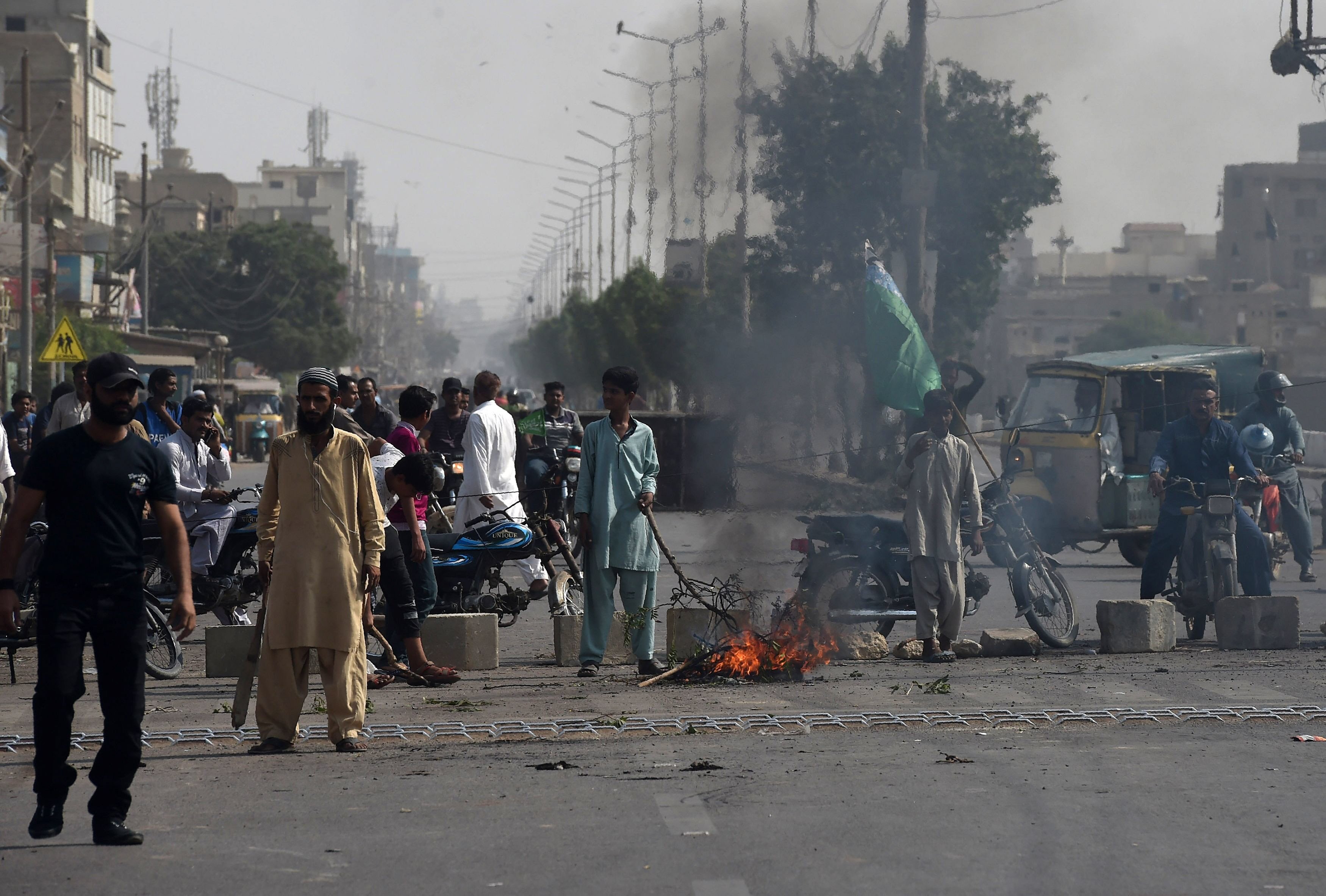 TLP supporters on a blocked street during protests. — AFP