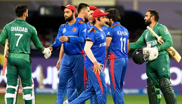 Pakistan´s Asif Ali (R) and teammate Shadab Khan (L) shake hands with Afghanistan´s players at the end of the ICC Twenty20 World Cup cricket match between Afghanistan and Pakistan at the Dubai International Cricket Stadium in Dubai on October 29, 2021 — AFP.