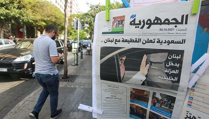 A man walks near a newspaper with a headline that reads  Saudi Arabia announces a boycott with Lebanon in Beirut, Lebanon, October 30, 2021. — Reuters
