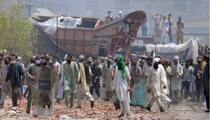 Proscribed TLP supporters with sticks and stones block a road during a protest in Lahore, Pakistan, April 18, 2021. Photo: Reuters