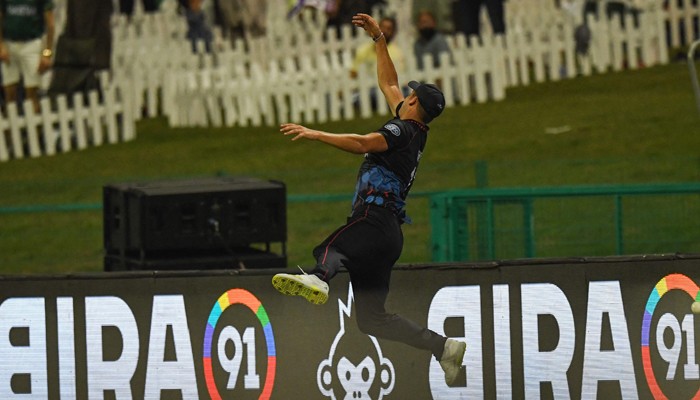 Namibias JJ Smit dives in the air to attempt a catch during the ICC Twenty20 World Cup cricket match between Namibia and Pakistan at the Sheikh Zayed Cricket Stadium in Abu Dhabi on November 2, 2021. — AFP