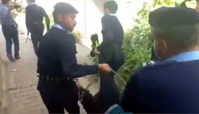 Zahir Jaffer, in handcuffs, is being removed from an Islamabad court by police officers. Photo: screengrab