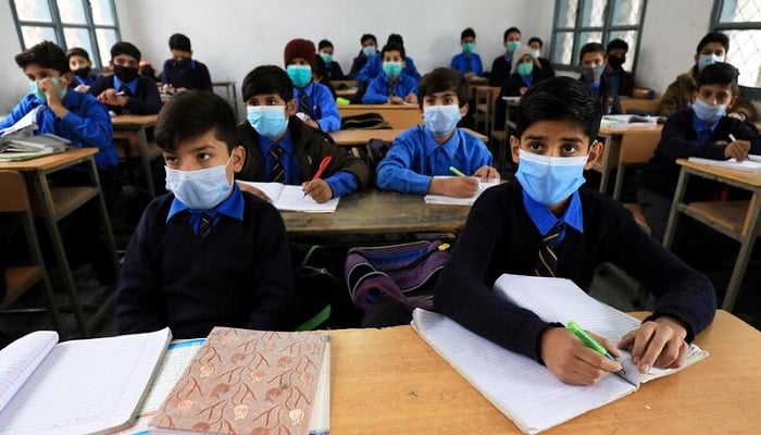 A file photo of students wearing protective masks as they attend a class at school during the COVID-19 pandemic in Peshawar, Pakistan. Photo: Reuters