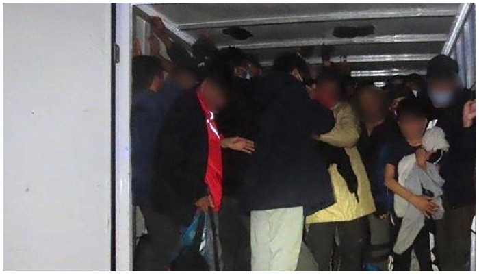 A group of migrants smuggled in a truck at an unknown location. — Europol /AFP
