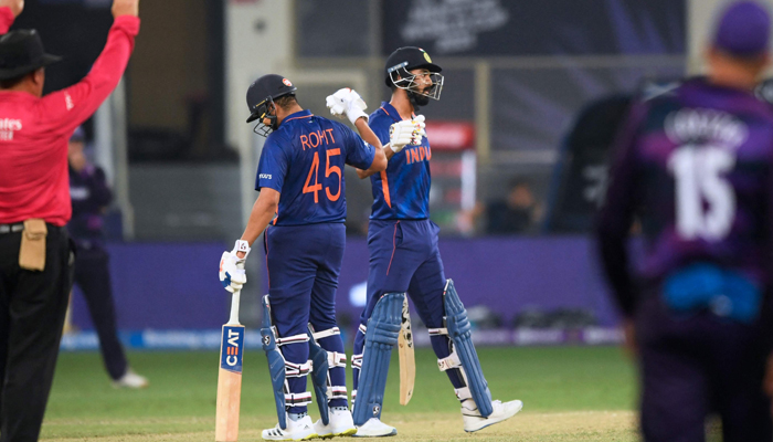 India´s KL Rahul (R) celebrates with teammate India´s Rohit Sharma after hitting a boundary shot during the ICC Twenty20 World Cup cricket match between India and Scotland at the Dubai International Cricket Stadium in Dubai on November 5, 2021. — AFP