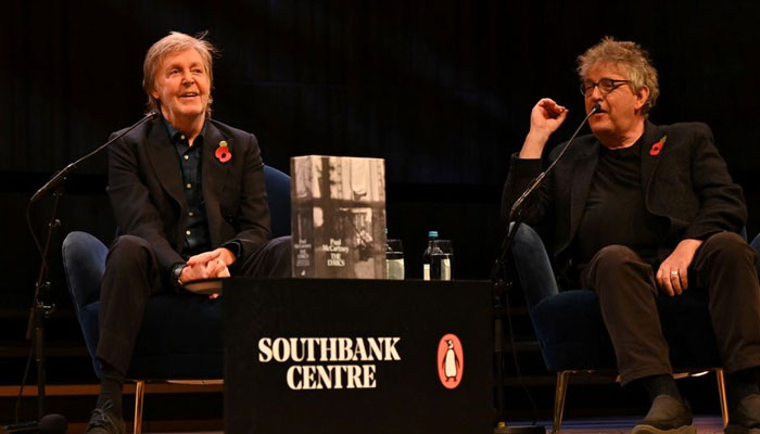 Paul McCartney is seen on stage at the Southbanks Royal Festival Hall in conversation with Paul Muldoon (editor) and Samira Ahmed (unseen) in London, Britain, November 5, 2021, in this handout photo / Reuters