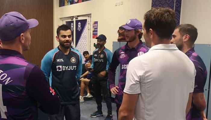 Indian captain Virat Kohli speaks to the Scottish cricketers in their dressing room. Photo: Cricket Scotland Twitter