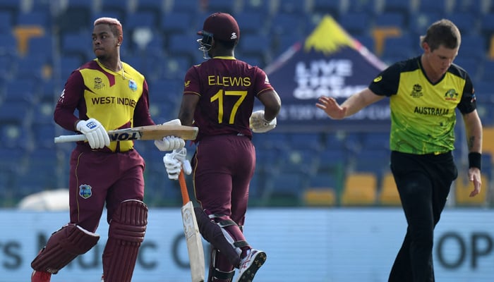 West Indies´ Shimron Hetmyer (L) and Evin Lewis run between the wickets during the ICC Twenty20 World Cup cricket match between Australia and West Indies at the Sheikh Zayed Cricket Stadium in Abu Dhabi on November 6, 2021. — AFP