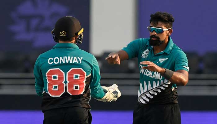 New Zealands Ish Sodhi (R) celebrates with teammate Devon Conway after taking the wicket of Scotlands George Munsey (not pictured) during the ICC Mens Twenty20 World Cup cricket match between New Zealand and Scotland at the Dubai International Cricket Stadium in Dubai on November 3, 2021. — Photo by Aamir Qureshi /AFP