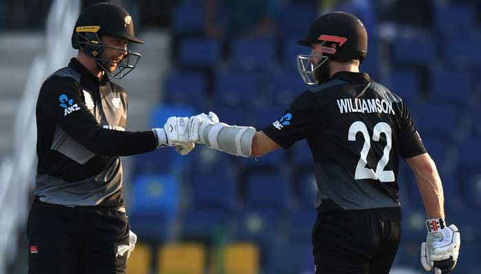 New Zealand´s Devon Conway (L) and captain Kane Williamson bump their fists after a boundary during the ICC menâ€™s Twenty20 World Cup cricket match between New Zealand and Afghanistan at the Sheikh Zayed Cricket Stadium in Abu Dhabi on November 7, 2021. — Photo by Indranil Mukherjee/AFP