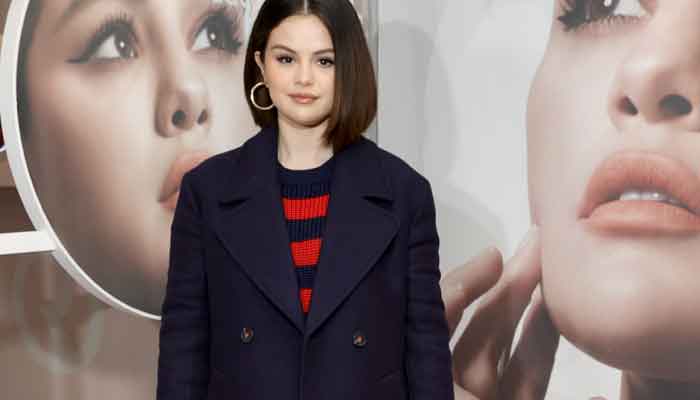 Selena Gomez shows off her elegance in navy coat and long boots during a shoot