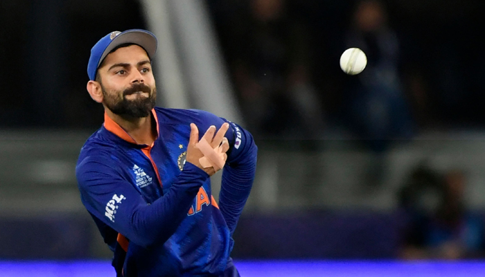 Indias captain Virat Kohli throws the ball during the ICC Twenty20 World Cup cricket match between India and Namibia at the Dubai International Cricket Stadium in Dubai on November 8, 2021. — AFP