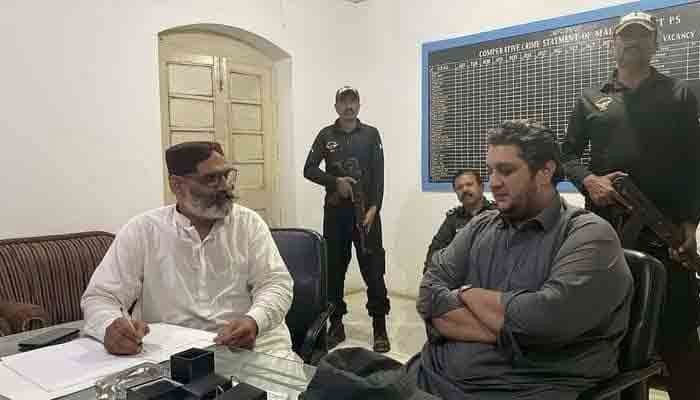 Suspect PPP MPA Jam Owais (R) seen at a police station in this file photo shared on Twitter @Xadeejournalist