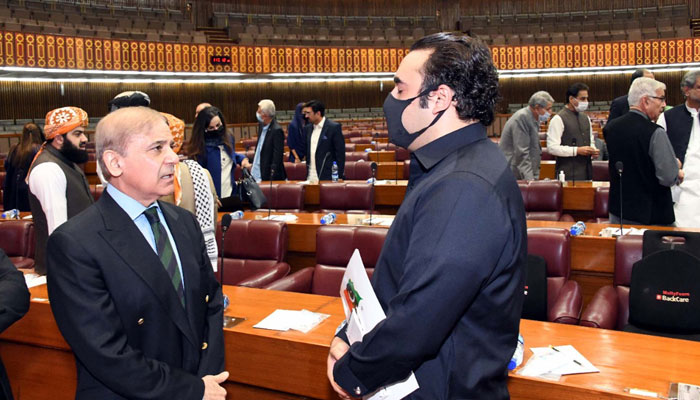 PPP Chairman Bilawal Bhutto Zardari interacts with PML-N President Shahbaz Sharif ahead of a session of the National Assembly in Islamabad on November 08, 2021. — PPI/File