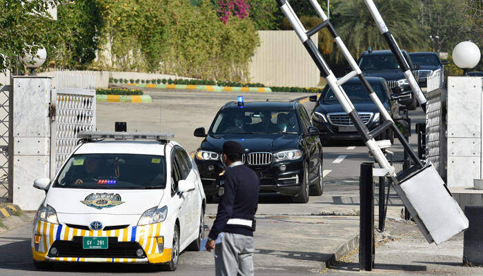 The convoy of Prime Minister Imran Khan leaves from the Supreme Court in Islamabad on November 10, 2021, after he had been summoned over the government's inaction against those responsible for the Army Public School (APS) attack in 2014. — AFP