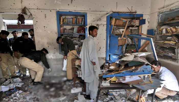 Police officers inspect a bomb blast site. Photo: File