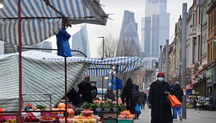 People shop at market stalls, with skyscrapers of the City of London financial district seen behind, amid the coronavirus disease (COVID-19) pandemic, in London, Britain, January 15, 2021. — Reuters/File