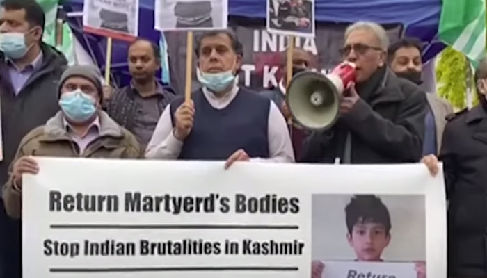 Protesters hold placards in from of central offices of European institutions in Brussels. — YouTube/GeoNews