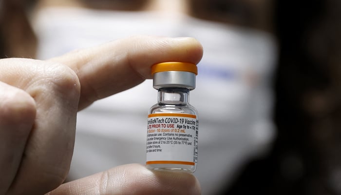 An Israeli health worker displays a vial of the Pfizer/BioNTech COVID-19 vaccine for children, at the Meuhedet Healthcare Services Organisation in Tel Aviv on November 22, 2021. — AFP