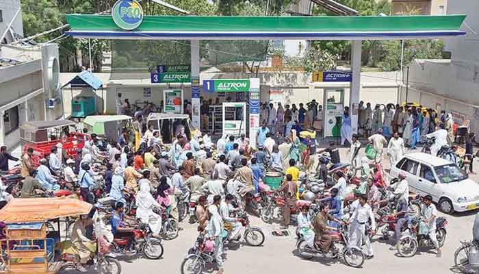 Motorists throng to a petrol pump amid petroleum dealers strike.