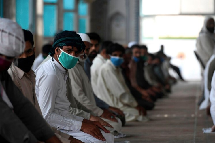 Muslim devotees wearing protective masks offer Friday prayers at the Jamia Masque during the Islamic holy fasting month of Ramadan in Rawalpindi, Pakistan, on Friday. — Aamir Qureshi/AFP/Getty Images