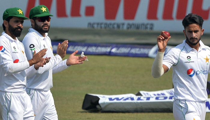 Hasan Ali (R) shows the ball as he celebrates along with his teammates after taking five wickets on the second day of the first Test cricket match between Bangladesh and Pakistan at the Zahur Ahmed Chowdhury Stadium in Chittagong on November 27, 2021. — AFP