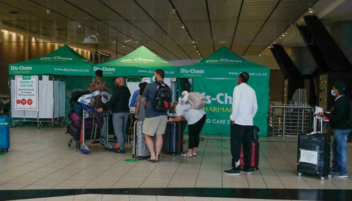 Travellers queue for Covid tests at Johannesburg airport on November 27, 2021, after several countries banned flights from South Africa following the discovery of a new Covid-19 variant. AFP
