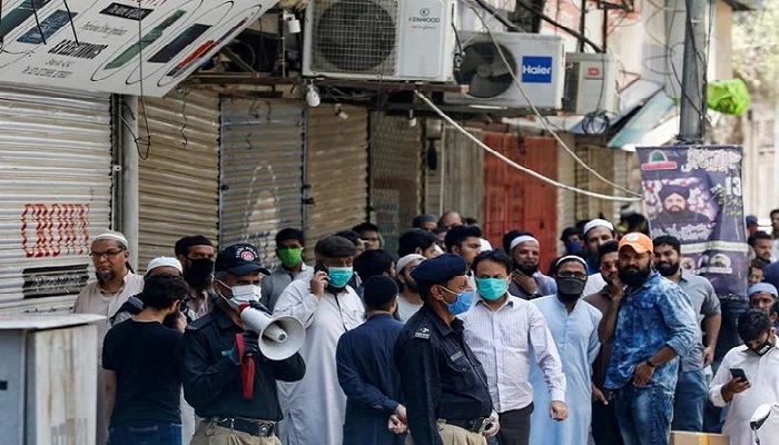 In this file photo, a police officer uses a megaphone to disperse shopkeepers, who gather to reopen their shops at a closed electronics market, during a previous lockdown as part of efforts to stop the spread of the coronavirus (COVID-19), in Karachi, Pakistan on April 27, 2020. Photo: Reuters