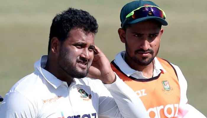 Yasir Ali walks back to pavilion rubbing the back of his head after being struck on the helmet. Photo: Twitter