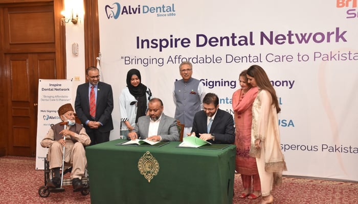 President Dr Arif Alvi and his son Awab Alvi during the MoU signing between Alvi Dental and Bringing Smiles USA. — Twitter/Awab Alvi/File