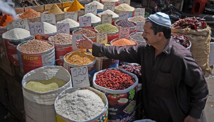 In this file photo, a Pakistani customer checks pulses at the main wholesale market in Karachi. Photo: AFP