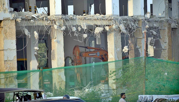 A view of demolition work of the Nasla Tower being razed on the orders of the Supreme Court of Pakistan on November 27. — APP/File